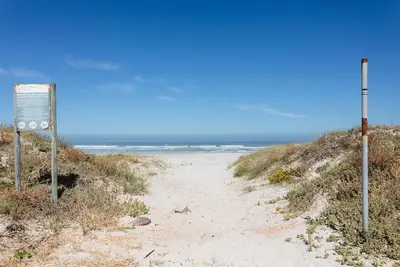 Image de Kite boarding and wind surfing all year round on a blue flag beach.
