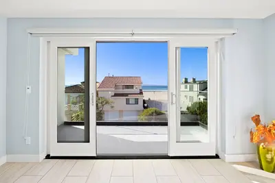 Ocean view modern home with bikes, grill, game tables, fireplace, W\/D, & Ac