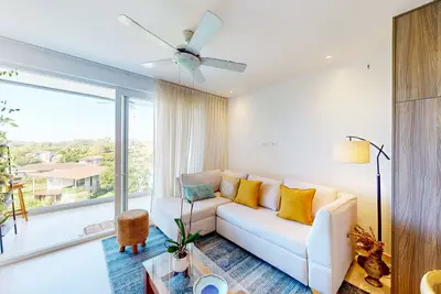 4th-floor condo with water view, on-site pool, private balcony, & W/D