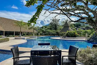 Airy tropical home with pool access, enclosed yard, hammock, Ac, & W/D