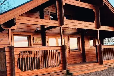 A traditional Scandinavian style lodge, with stylish wooden interior decorated with a Scottish theme
