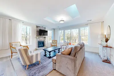 Image de Newly built riverfront home with dock, kayaks, basketball court, & game room