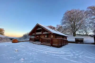 A traditional Scandinavian style lodge, with stylish wooden interior decorated with a Scottish theme