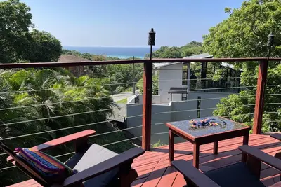 Nestled on a lush hillside, offering comfort, sea views, and beach access.
