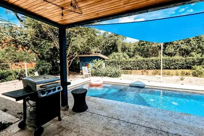 Well-equipped tropical retreat with a private pool, grill, open layout, & W\/D