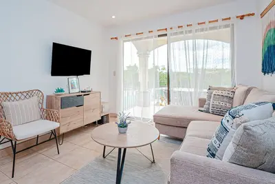 Modern condo near beaches with mountain views, outdoor pool, balcony, W/D, Ac