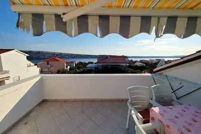 Image de Appartement de deux chambres avec la terrasse et la vue sur le mer Barbat, Rab (A-22217-c)