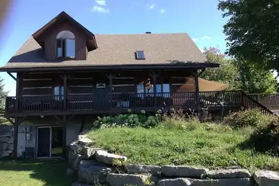 Image de Waterfront log home on Lake Dore. Decks, dock, outdoor hot tub and fire pit.