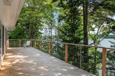 Image de Coastal Hideaway. Water views with expansive deck, pool table, office area.