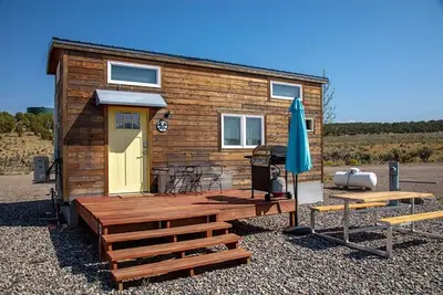 Image de Lion Canyon was built by Mitchcraft in Fort Collins, Colorado as part of Hgtv's \"Tiny House Hunters\". This home has two lofts, each with a Queen bed. One is accessible by stairs and one by ladder.