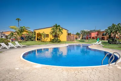 Home in a gated community with outdoor pool, patio, grill, streaming, W\/D, & Ac