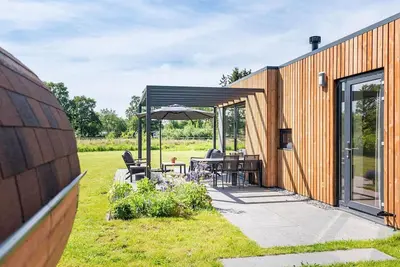 Image de The 6-person holiday villa Amalia with a private sauna has a spacious living room, an open kitchen, three bedrooms, and a spacious terrace.