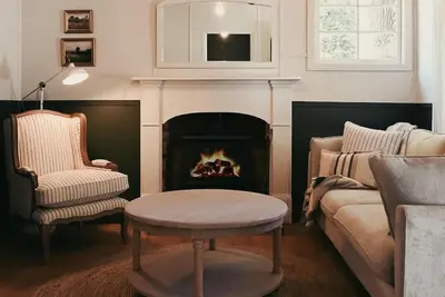 Image de Woodleigh Estate - Step into a world of timeless elegance and unparalleled charm at Woodleigh Estate. This historic 1860's home is nestled on a one acre estate landscaped with cottage like gardens. From the moment you enter the home you are envelope