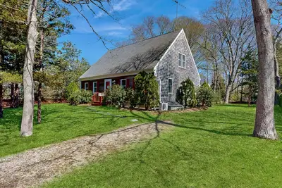 2-story home near the beach with large lawn, deck, W/D, streaming, & partial Ac