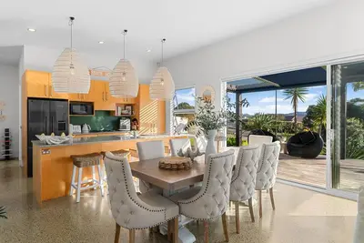 Image de All Decked Out - Modern holiday home with multiple decks including a covered outdoor entertaining space with open fireplace and plastic blinds. Close to shops, cafe, golf course, estuary and Mangawhai Activity Zone. Pet Friendly.