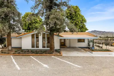 Image de Single-level home surrounded by lush gardens with a washer/dryer, Ac, & wet bar