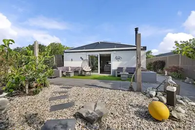 The charmingly furnished holiday home with luxurious amenities and a spacious private garden is located near the sea and dunes.