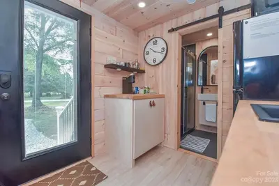 Image de Scandinavian tiny home surrounded by nature with patio, solo fire pit, grill.