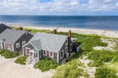 Ocean front renovation nestled into the dune on a private East Sandwich beach.