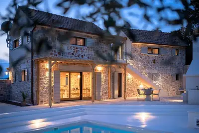 Image de Modern expression of a traditional Hvar stone house amidst sunny nature.