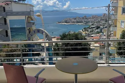 The apartment has a beautiful view of the city and the sea with a balcony.