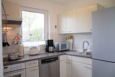 Image de Vacation home Kiebitzmoor 7, at ground level and surrounded by greenery.