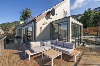 Image de Mountain and lake views and wood burner inside.