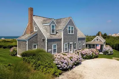 Superb quality cottage situated on Wauwinet Harbor with abounding view.