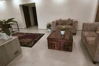 Image de A two-bedroom home with a living room, kitchen, and garden feels like home. \n