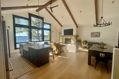 Image de New, stunning modern lake home with private swimming beach and dock