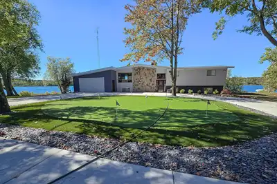 Lakefront home w/ large patio, dock, putting green, gas grill, fire pit, & Wifi