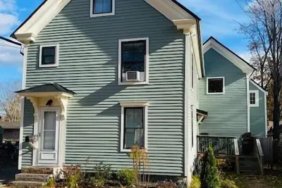 Image de Renovated farmhouse featuring two connected rental units with an interior access door. Large Yard