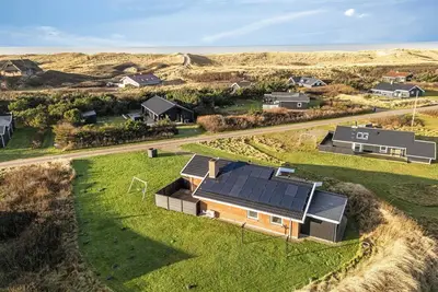 Lovely holiday home with pool, spa and sauna, only 200 meters from the North Sea.