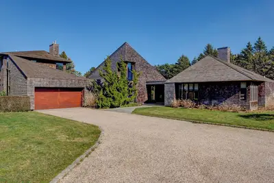 Image de Glam-style home with private pool, open-floor plan, floor-to-ceiling. . .