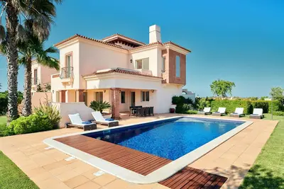 Image de Escape to a Monte Rei villa with pool and garden views.
