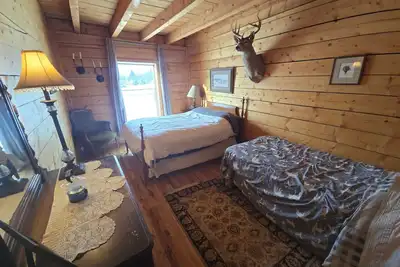 Image de Room 2 at the Main Lodge with a queen bed and single bed.
