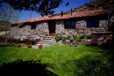 Old house in the mountain made of stone, rock and wood. Private garden and barbecue