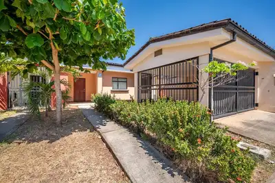 Home in a gated community with outdoor pool, patio, grill, streaming, W/D, & Ac