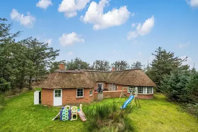 Family-friendly holiday home with pool and spa close to the North Sea.