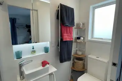 Newly finished self-contained unit above Arkles Bay watch sunset over Auckland