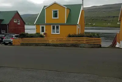 Image de The Little Yellow House Cozy Old Faroese wooden house.