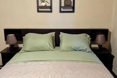 Double room with queen size bed and sofa bed, terrace and plants