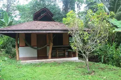 Romantic bungalow in the middle of a tropical garden, close to the beach.