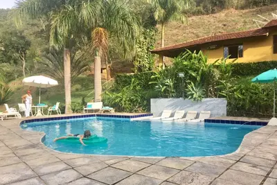 Image de Private waterfall in the garden, swimming pool with small beach and stream with natural pool