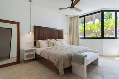 Image de Discover a peaceful jungle penthouse featuring 2 bedrooms, 3 baths, and a rooftop with tree-top views. Blending clean design and natural textures, this modern escape sits just minutes from the beach in Tulum - perfect for relaxing or adventuring.