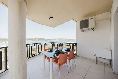 Image de Beautiful seafront apartment in Għadira Bay with 2 bedrooms, 2 bathrooms, and a large terrace offering breathtaking sea views. Located on the second floor (no lift) and just 1 minute from the sandy beach — ideal for a relaxing seaside escape.