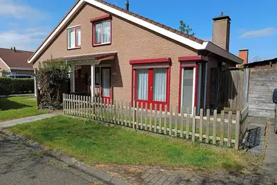 Image de The type Strandparel  located at the Schoneveld holiday park  is a cosy semi-detached house with garden and terrace. There is a spacious living room with an open kitchen and a cosy fireplace.