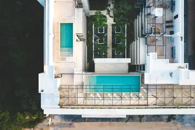 Image de Stay in the heart of Tulum in a modern two-bedroom condo offering rooftop pools with Mayan ruin views, a lush garden patio, and walkable access to the area’s best dining and shopping.