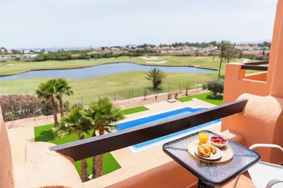 Sunny apartment overlooking pool, golf course and sea.
