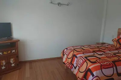 Image de Room with a bed, sofa bed, kitchenette and bathroom.